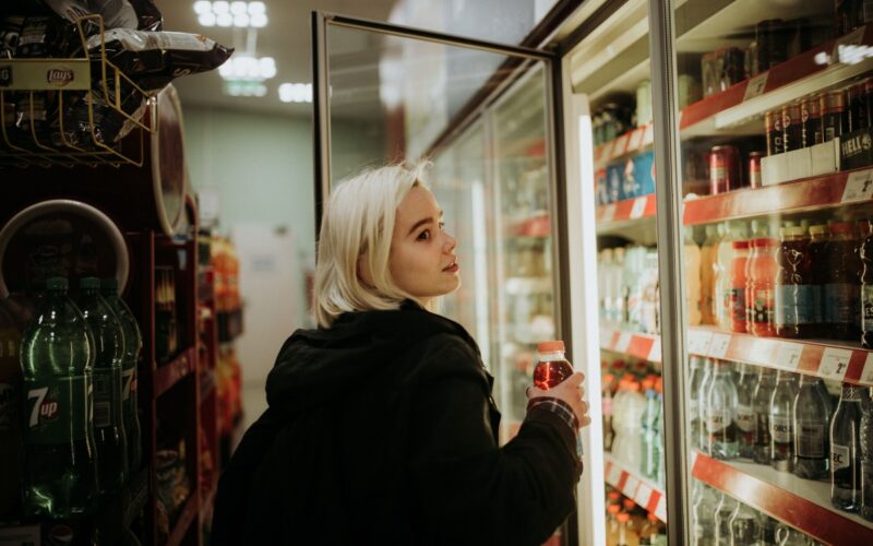 A woman buying an energy drink